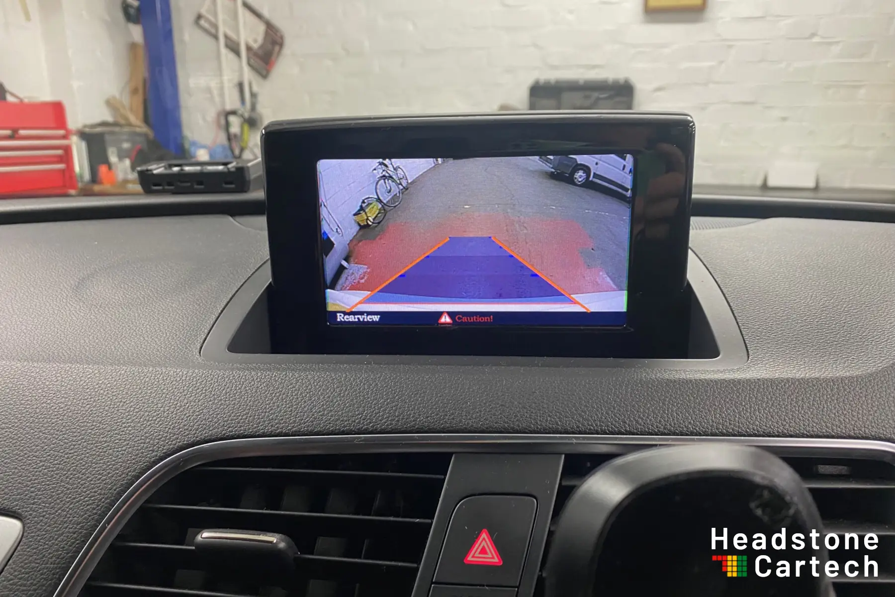 Reversing camera image displayed on the original Audi Q3 MMI screen after upgrade at Headstone Cartech in Harrow